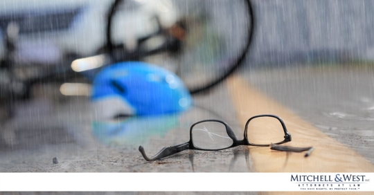 glasses and bicycle helmet in the rain after biker was hit by a car