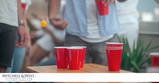 college student with a ping pong ball and red solo cups